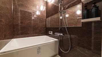 Separate bathtub and shower, free toiletries, hair dryer, slippers