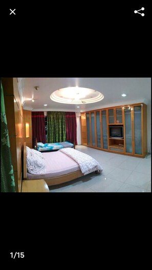 Cozy retreat with a single bed, wardrobe, and TV.