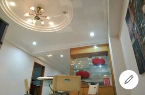 Enjoy meals in a stylish dining area with a glass display case showcasing fresh produce.
