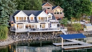 A waterfront property with a large house featuring multiple decks and a dock. - Stellamar on Hayden, Close-in Executive Waterfront (Hayden)