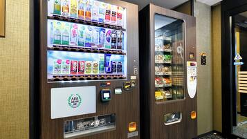 A vending machine with a variety of beverages and snacks.