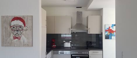 Fridge, stovetop, dishwasher, coffee/tea maker