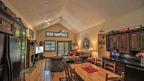 A spacious kitchen with wooden cabinets, a dining table, and a built-in oven. - 'Brookmont Lodge' Right Off Sugar Golf Course! (Sugar Mountain)