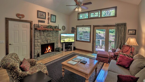 A living room with a fireplace, a television, and a comfortable seating area. - 'Brookmont Lodge' Right Off Sugar Golf Course! (Sugar Mountain)