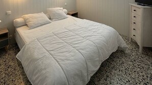 A neatly arranged bedroom with a bed, bedside tables, a TV, and a window with curtains. - Very nice apartment with sea view and private parking 4SUF502 (LE BARCARES)