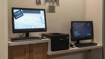 A computer station with two monitors, a keyboard, and a mouse.