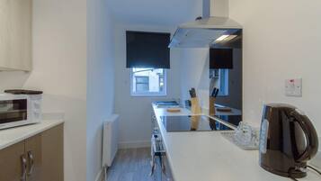 The Bay Family Apartment ground floor (Apartment 1) | Private kitchen | Fridge, microwave, oven, stovetop