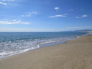 A beach with a clear sky and calm sea.