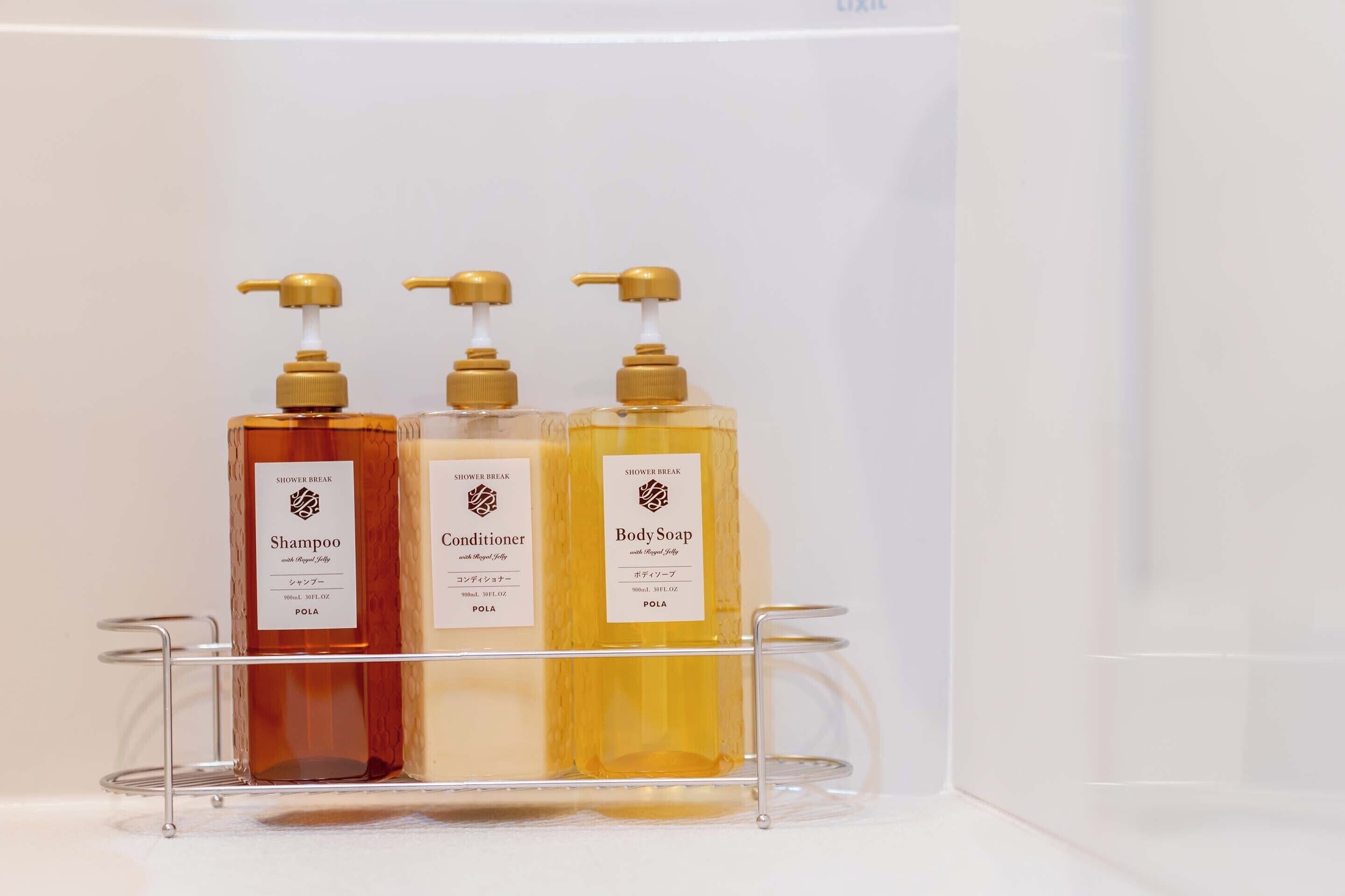 Three bottles of Shower Break products on a clear shelf.