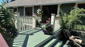 A house with a porch, a front door, and a small garden area. - Character Stay across Swan Lake Nature Sanctuary (Victoria)
