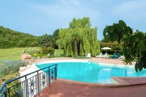 A swimming pool with a clear blue water, surrounded by a garden with various plants and trees. - Villa Dipendenza, Historic Holding with  wonderful swimming pool (murlo - siena, tuscany)