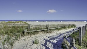 A sandy beach with a wooden fence and a clear blue sky. - LOCATION,PRACTICALITY AND COMFORT MEET! BEACH BLOCK! BRING YOUR EXTENDED FAMILY! (Atlantic City)