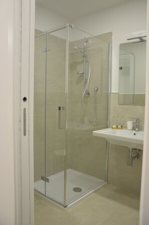 Deluxe Double Room, 1 Queen Bed, Ground Floor (Malve) | Bathroom | Shower, hair dryer, slippers, bidet - In & Out Matera (Matera)