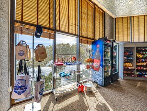 A spacious room with large windows, a vending machine, and a display of various items.