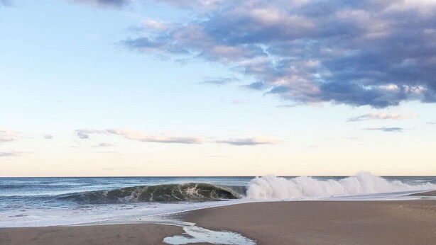A beach with waves crashing onto the shore under a partly cloudy sky. - Stylish space, 180ft to beach,parking (Point Pleasant Beach)
