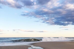 A beach with waves crashing onto the shore under a partly cloudy sky. - Stylish space, 180ft to beach,parking (Point Pleasant Beach)