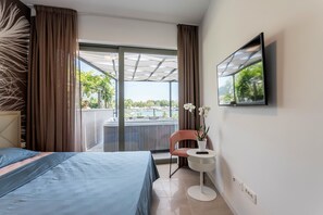 Relax in this serene space with a large bed, flat-screen TV, and outdoor access.