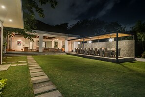 A modern outdoor patio with a seating area and a covered section. - Seminyak, Large Groups, 11 Bdr/14 beds,Near Beach (Seminyak)