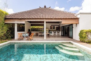 A house with a tiled roof, a swimming pool, and a covered outdoor seating area. - Spacious 1BR Villa in the heart of Seminyak  (Seminyak)