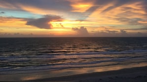 A sunset over the ocean with clouds. - Beautiful luxury 2 bedroom private   Cottage (Dunedin)