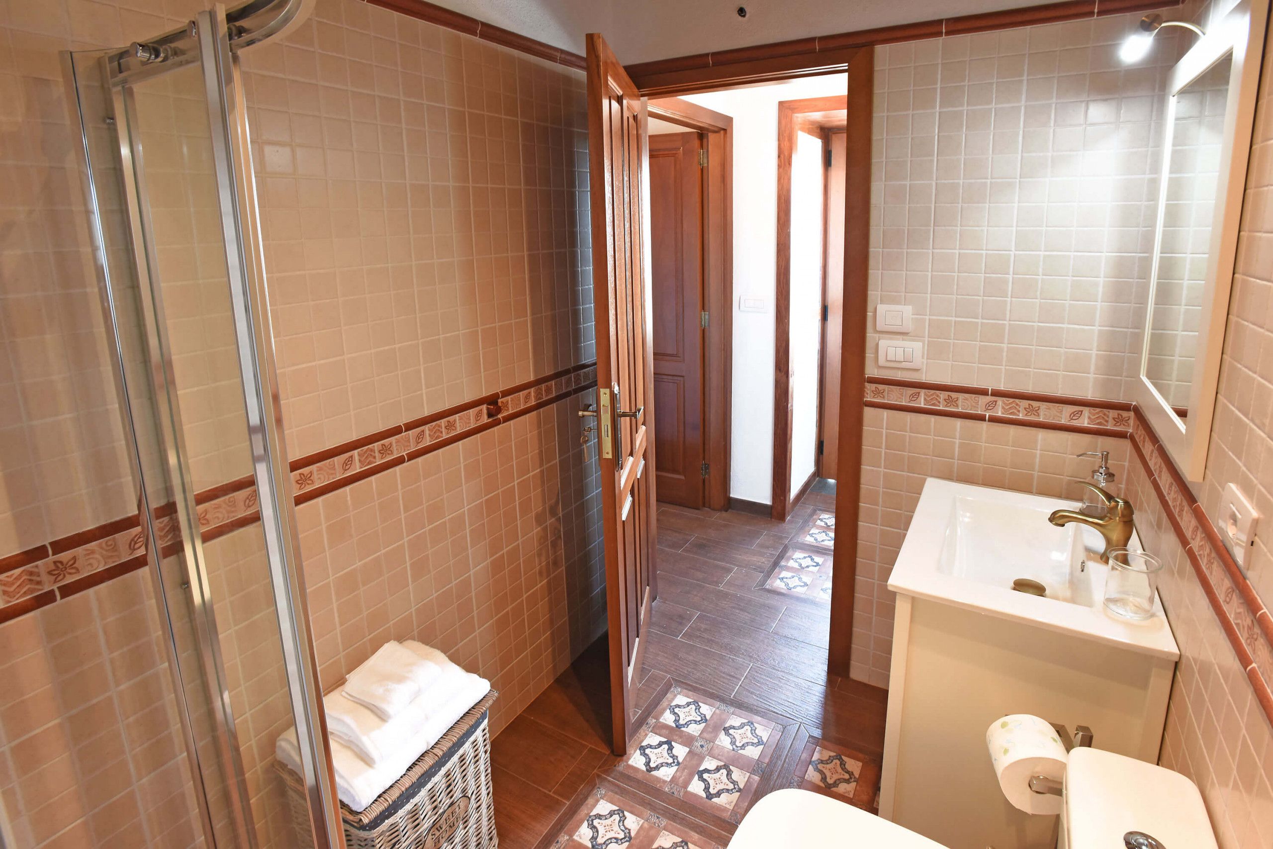 A bathroom with a shower, sink, and toilet.