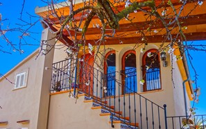 A building with a balcony, a staircase, and a window with a railing. - Son Antem 420 fantastic finca with private pool, terrace, barbecue and air conditioning (Llucmajor)