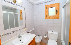 A bathroom with a white sink, mirror, and toilet. - Can Palea 407 finca with private pool with garden, terrace, barbecue and WiFi (Campos)