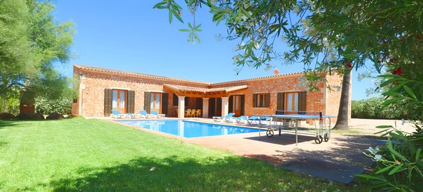 A two-story house with a swimming pool, outdoor seating, and a pergola. - Can Mates Nou 404 fantastic finca with private pool, terrace, ping pong and air conditioning. (Campos)