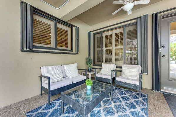A covered outdoor seating area with two sofas and a coffee table, a ceiling fan, and a door with a keypad lock. - 2 Mi to Beach! Oakland Park Home w/ Outdoor Oasis (Oakland Park)