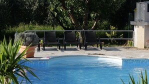 A swimming pool with a tiled edge, surrounded by a metal railing and several lounge chairs. - 5 stars, Family Apartment  Pero at Nature park close to Adriatic sea (Peracko Blato/Ploce)