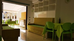 A modern hotel room with a sofa, green chairs, a table, and a balcony with a view. - B124 Seaside view Las Vistas TRG Tenerife Royal Gardens (Playa de la Américas)