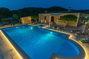 A rectangular swimming pool with a starfish decoration, surrounded by lounge chairs and a small building with a tiled roof. - VILLA ARHU - Villa with private pool in Capdepera. Free WiFi (Capdepera)