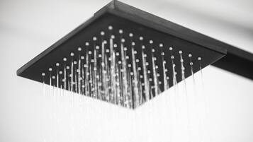 A close-up of a showerhead with multiple water jets.