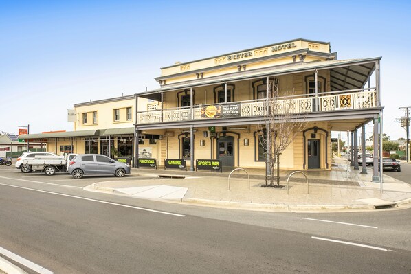 A two-story building with a balcony, labeled as a hotel. - Nightcap at Exeter Hotel (Exeter)