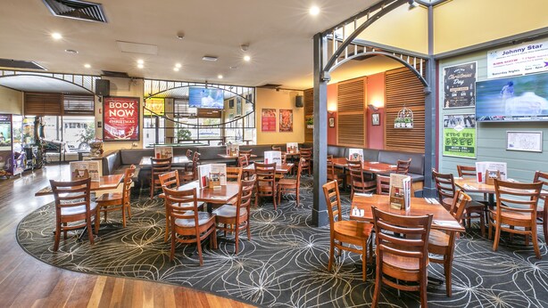 A restaurant with multiple dining areas, including booths and tables, with a variety of seating options. - Nightcap at Exeter Hotel (Exeter)