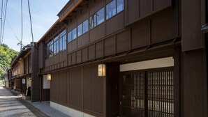 A traditional Japanese building with wooden exterior and sliding doors. - Utaimachi (Kanazawa)