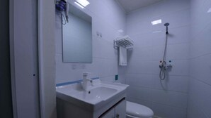 A small, clean bathroom with a white sink, mirror, and toilet. - Sucha Hotel Xi'an Xianyang Airport (Xianyang)