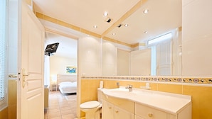 A bathroom with a toilet, sink, and mirror. - Studio Commandant André 33 by Viva Riviera (Cannes)