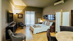 A modern bedroom with a bed, a desk, a chair, a dining table, and a TV. - NEW APARTMENT - Central Athens - Kolonaki, luxury modern flat.  (Athina)