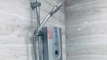 Shower, hair dryer, towels, shampoo