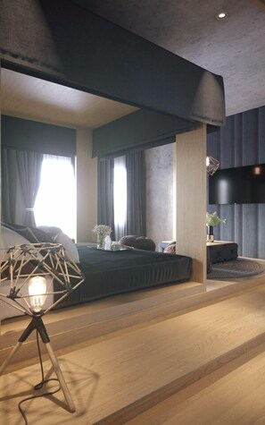 Un dormitorio moderno con una cama grande, una mesita de noche con lámpara y un televisor montado en la pared.