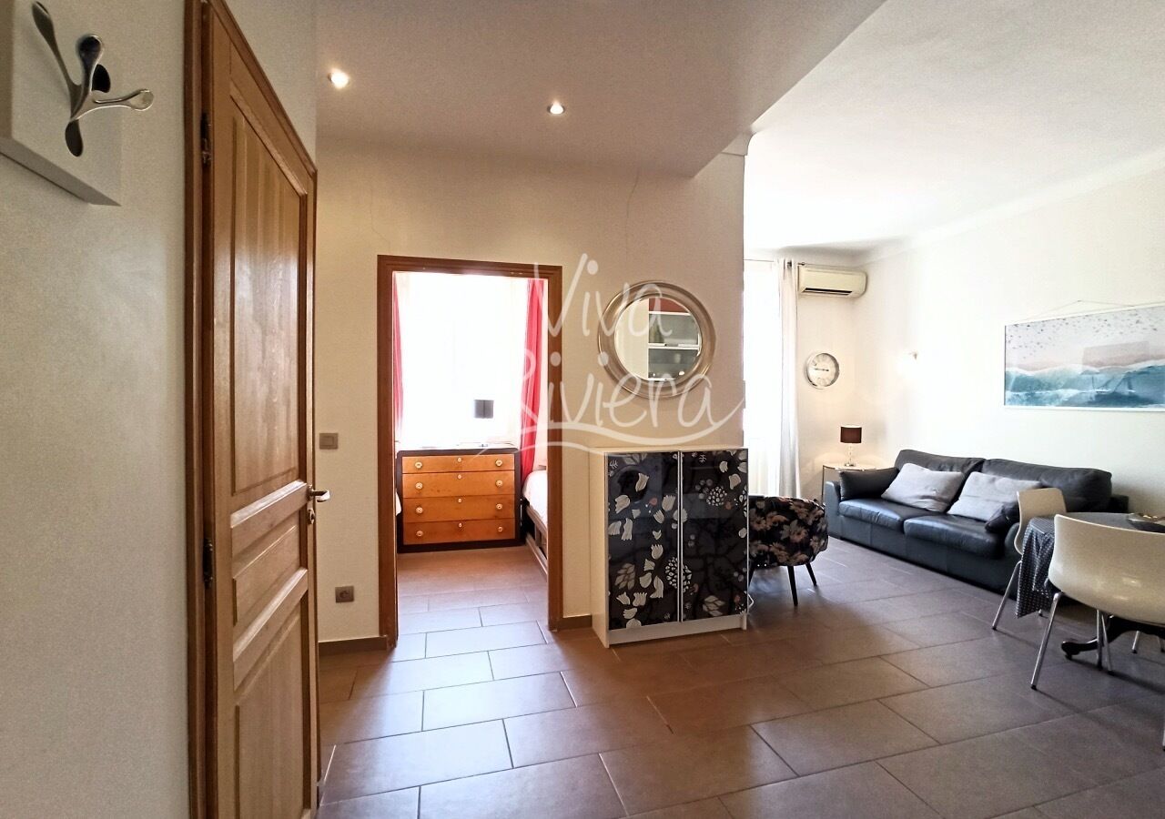 A spacious living room with a sofa, a coffee table, and a cabinet.