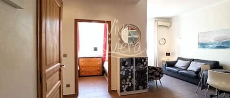 A spacious living room with a sofa, a coffee table, and a cabinet.
