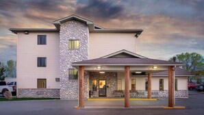 A two-story building with a stone facade and a covered entrance area. - Super 8 Billings (Billings)