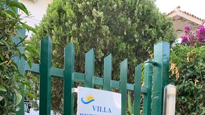 A green gate with a sign reading "Villa Petronilla". - 2 steps from the sea of the Gulf of Carini (Carini)