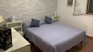 A bedroom with a bed, two nightstands, a lamp, a dresser, and a window. - 2 steps from the sea of the Gulf of Carini (Carini)