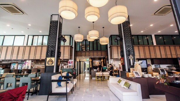 A spacious lobby with multiple seating areas, a reception desk, and a kitchen visible in the background. - The Experience Walking Street Chiang Mai (Chiang Mai)