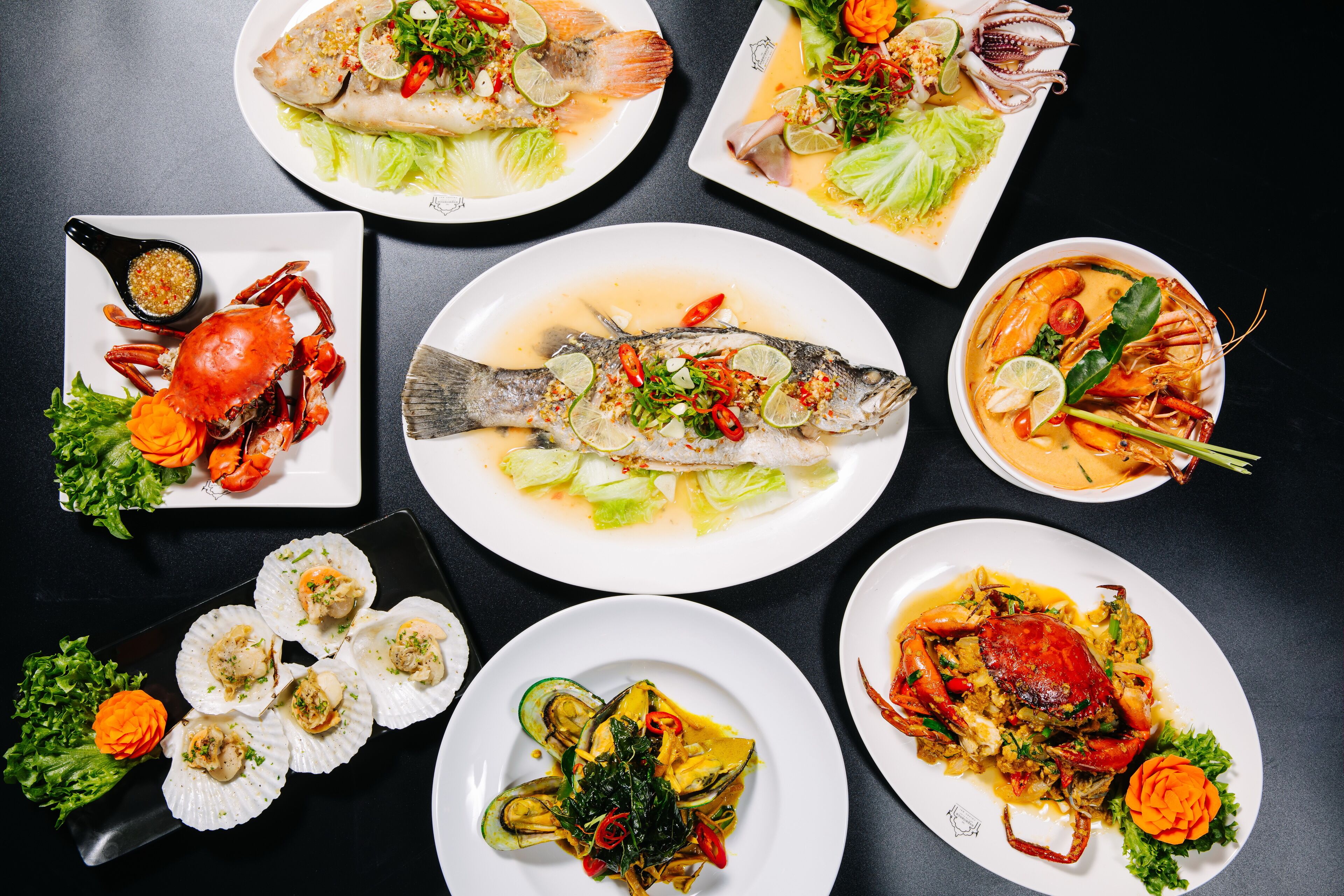A variety of seafood dishes arranged on plates.