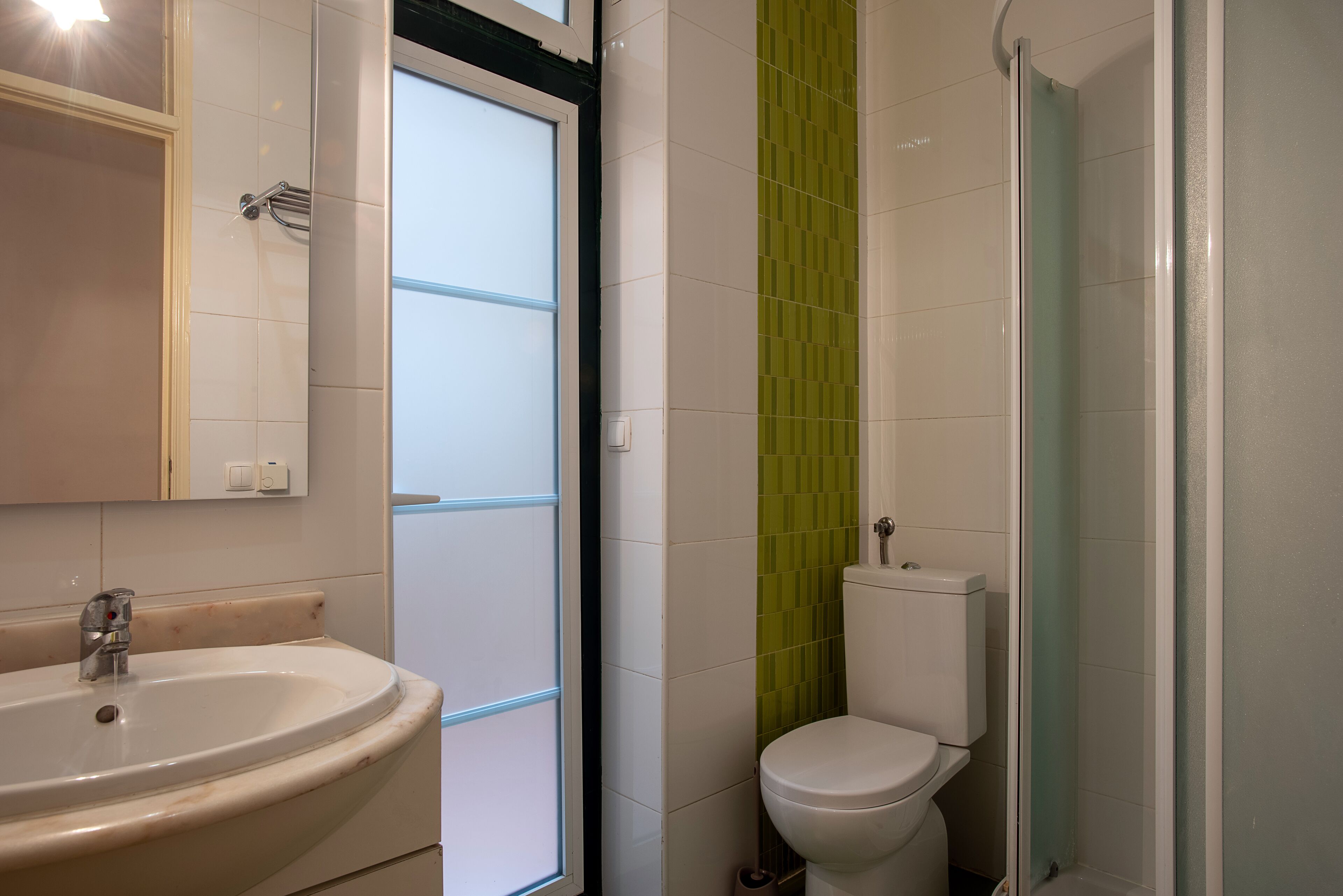 A bathroom with a sink, toilet, and shower.