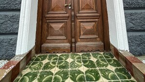 A wooden double door with a sign above it reading "GUEST HOUSE TOP FLOOR". - Guest House Top Floor (Telavi)